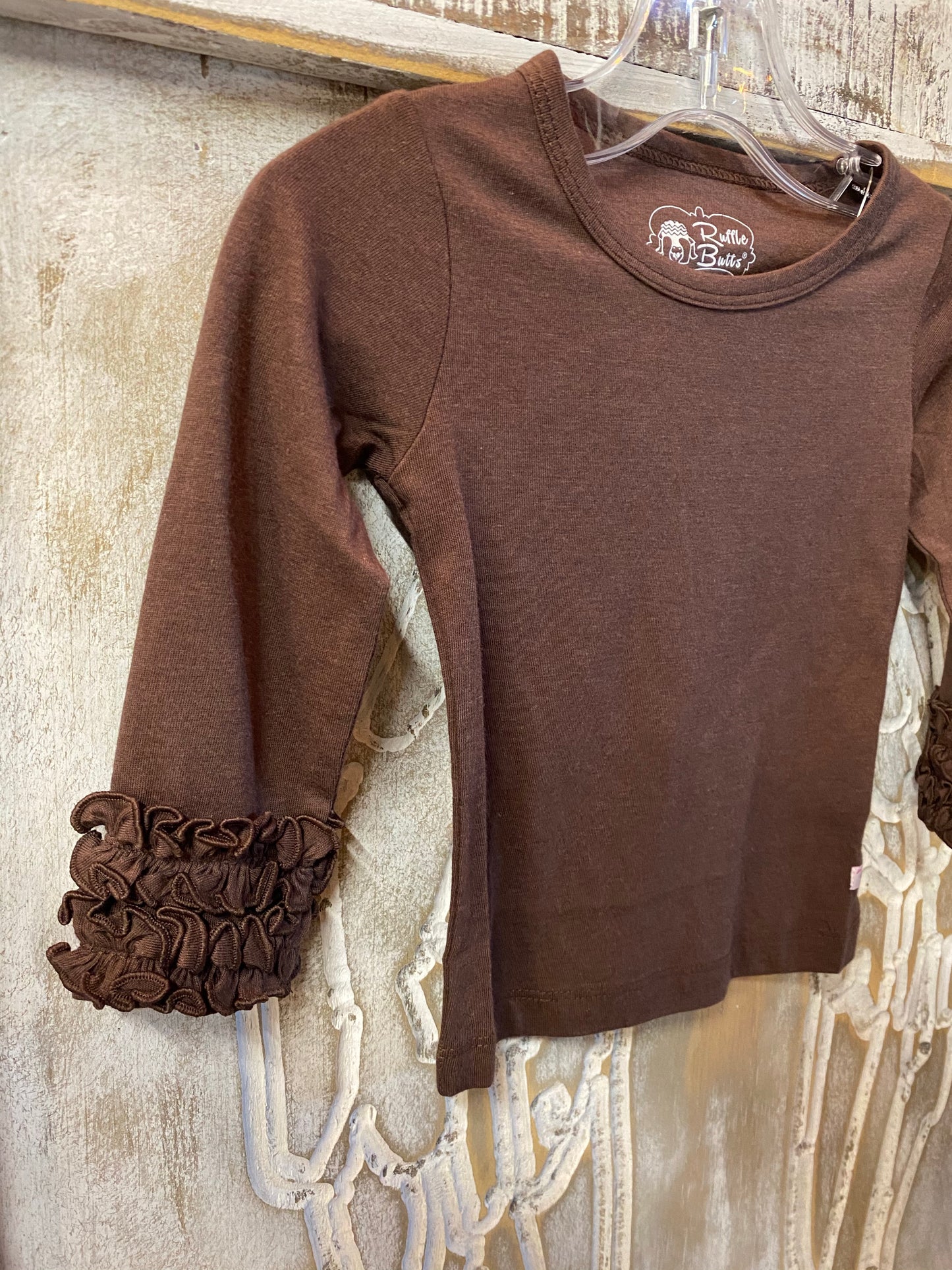 Brown top with ruffle sleeve cuffs