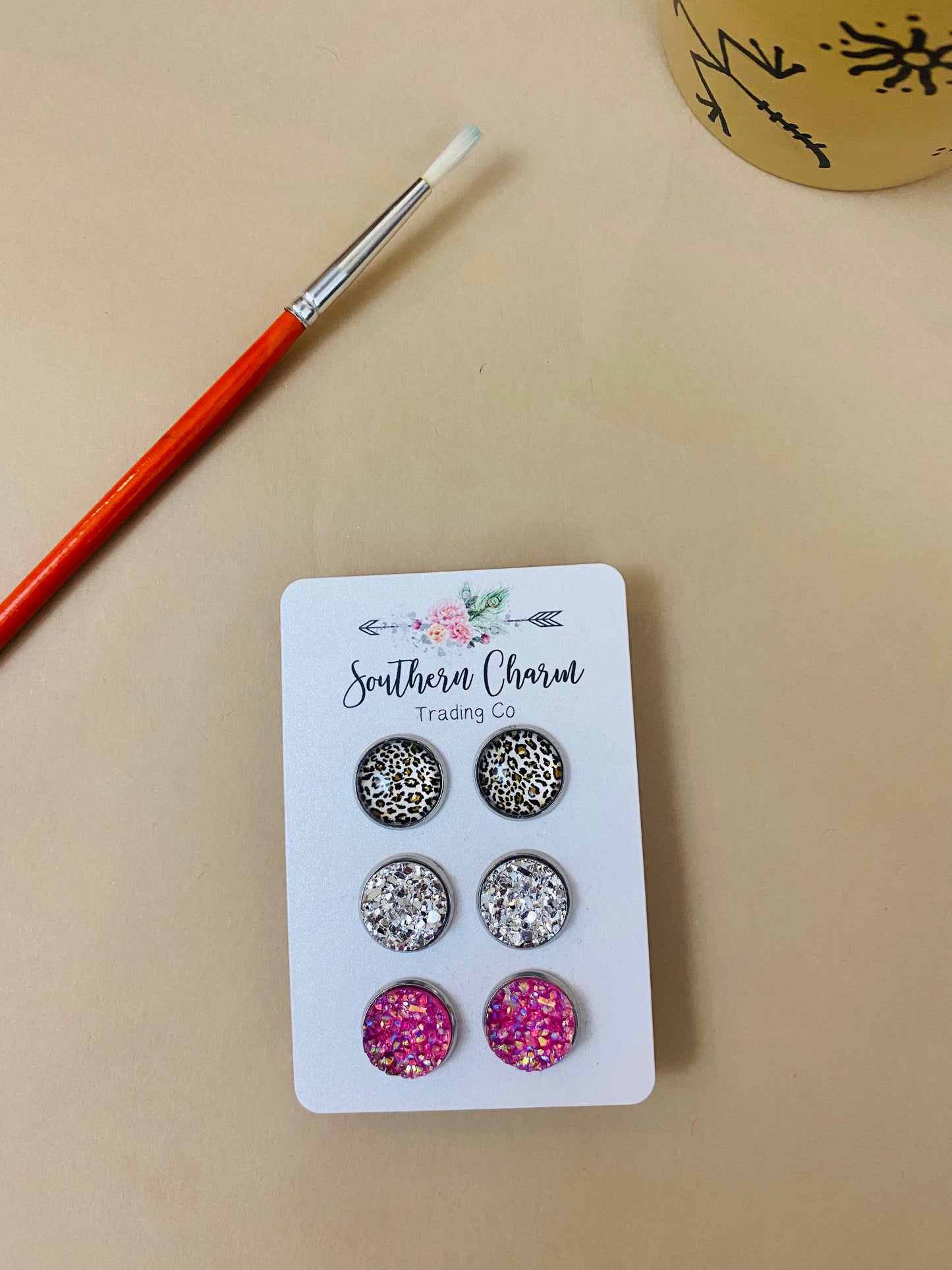 Leopard, sparkly silver, and sparkly pink stud earrings three pack